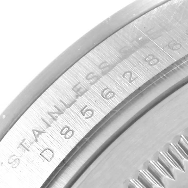 The image shows a close-up detail of the outer case with engraved text on the Explorer model by Rolex.