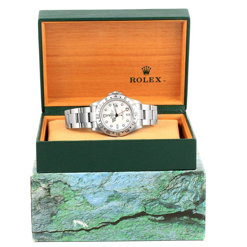 This image shows a Rolex Explorer 16570 Men's Stainless Steel White Dial 16570 Men's Stainless Steel White Dial watch displayed in an open green box with the Rolex logo on the inside lid.