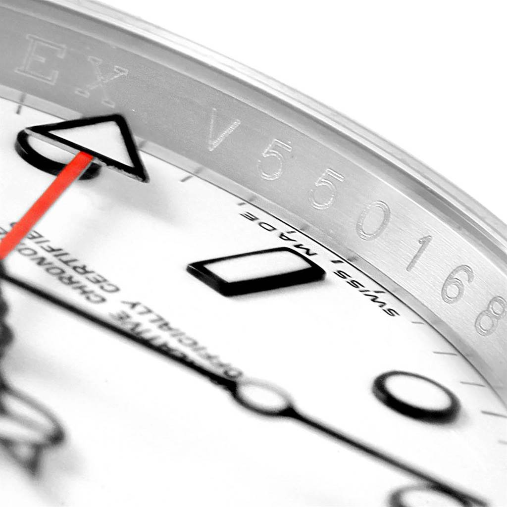 This close-up image of a Rolex Explorer 16570 Men's Stainless Steel White Dial 16570 Men's Stainless Steel White Dial watch shows part of the dial, the engraving on the inner bezel, and the hour and second hands.