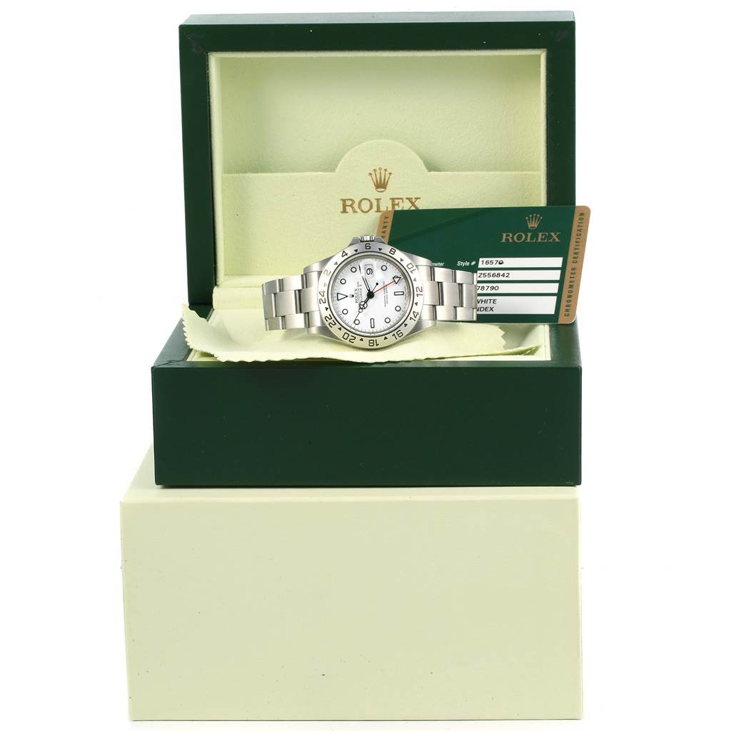 The Rolex Explorer 16570 Men's Stainless Steel White Dial 16570 Men's Stainless Steel White Dial watch is shown in its box with a warranty card beside it.