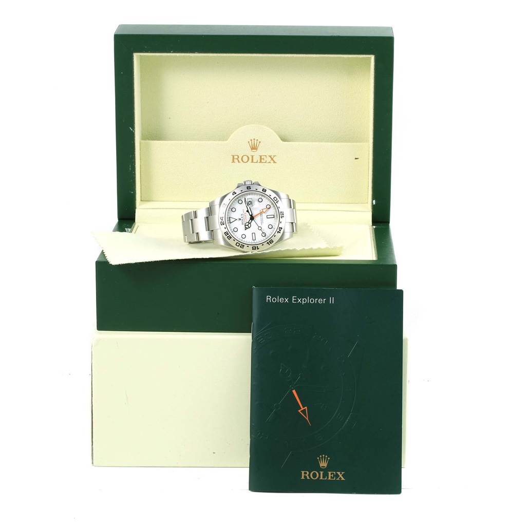 The image shows a Rolex Explorer 216570 Men's Stainless Steel White Dial 216570 Men's Stainless Steel White Dial watch from a front angle, resting in its open box with the manual in front.
