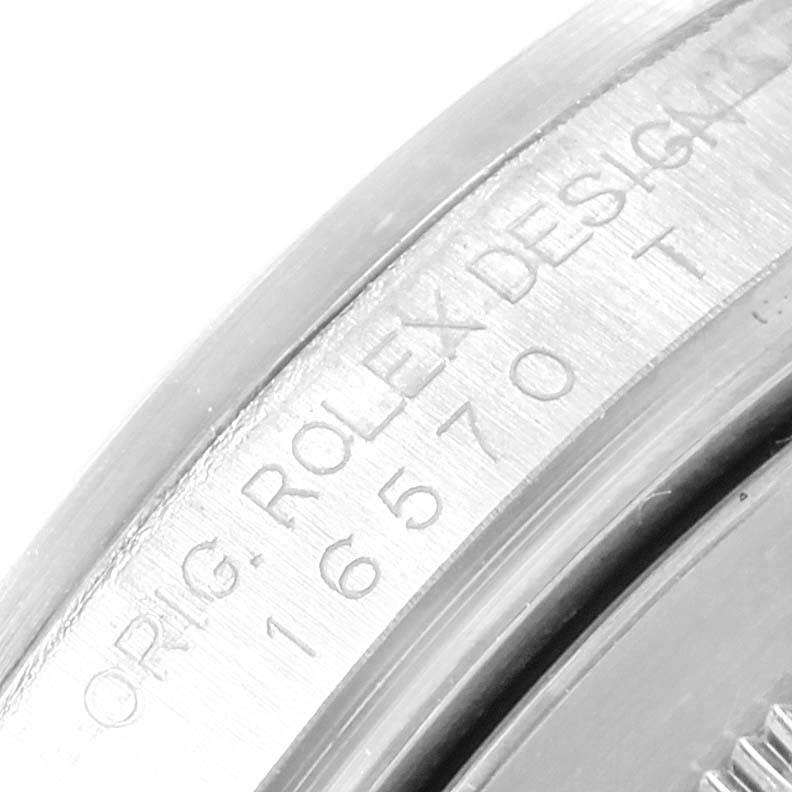 The image shows a close-up of the engraved model number and "Rolex Design" text on the case of a Rolex Explorer 16570 Men's Stainless Steel Black Dial 16570 Men's Stainless Steel Black Dial watch.