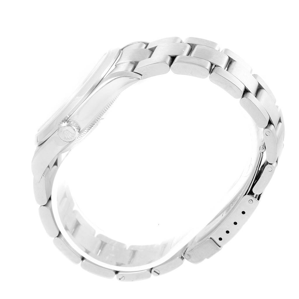 The Rolex Explorer 114270 Men's Stainless Steel Black Dial 114270 Men's Stainless Steel Black Dial watch is shown from a side angle, focusing on its stainless steel bracelet and the crown.