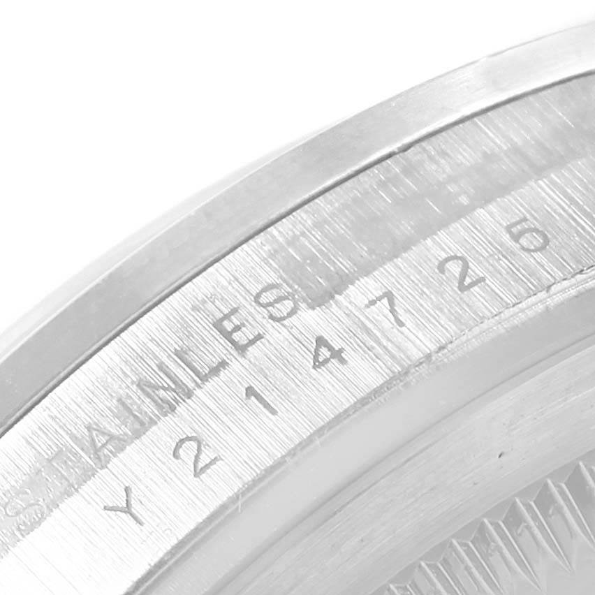 The image shows a close-up angle of the engraved bezel and serial number of a Rolex Explorer 114270 Men's Stainless Steel Black Dial 114270 Men's Stainless Steel Black Dial watch.