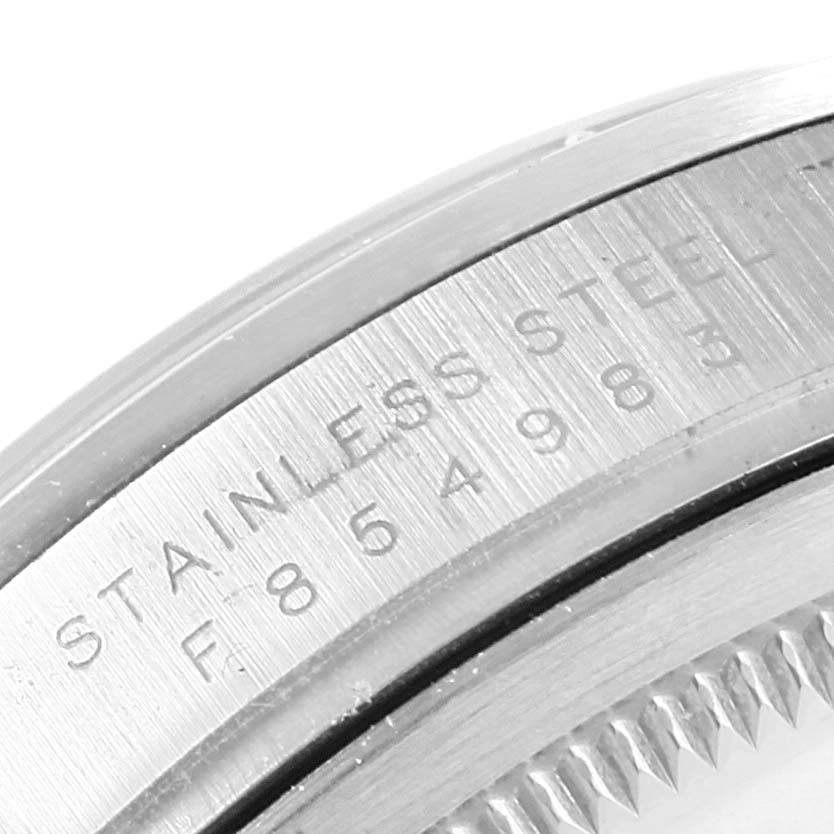 This image shows a close-up of the case side of a Rolex Explorer 114270 Men's Stainless Steel Black Dial 114270 Men's Stainless Steel Black Dial, highlighting the engraved serial number and "STAINLESS STEEL" text.
