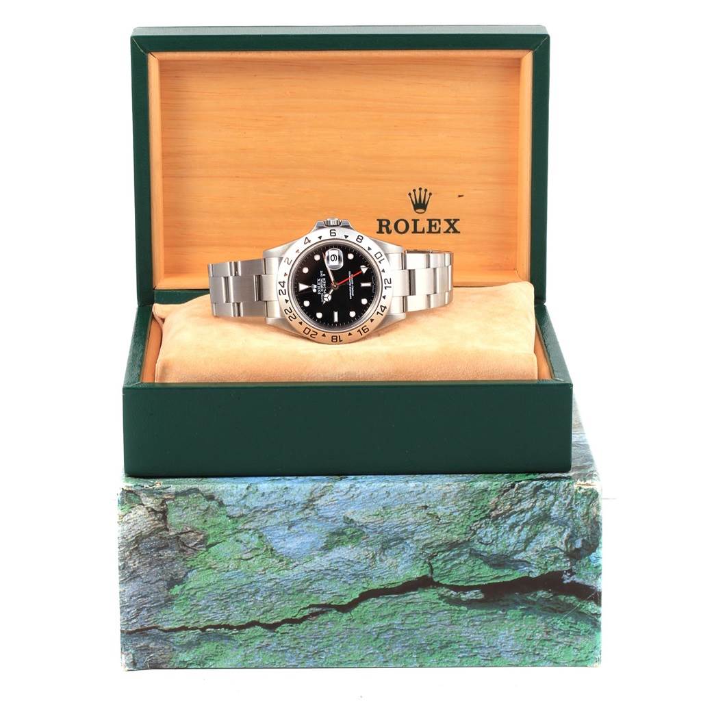 The Rolex Explorer 16570 Men's Stainless Steel Black Dial 16570 Men's Stainless Steel Black Dial watch is displayed front-facing inside its branded green and wooden box.