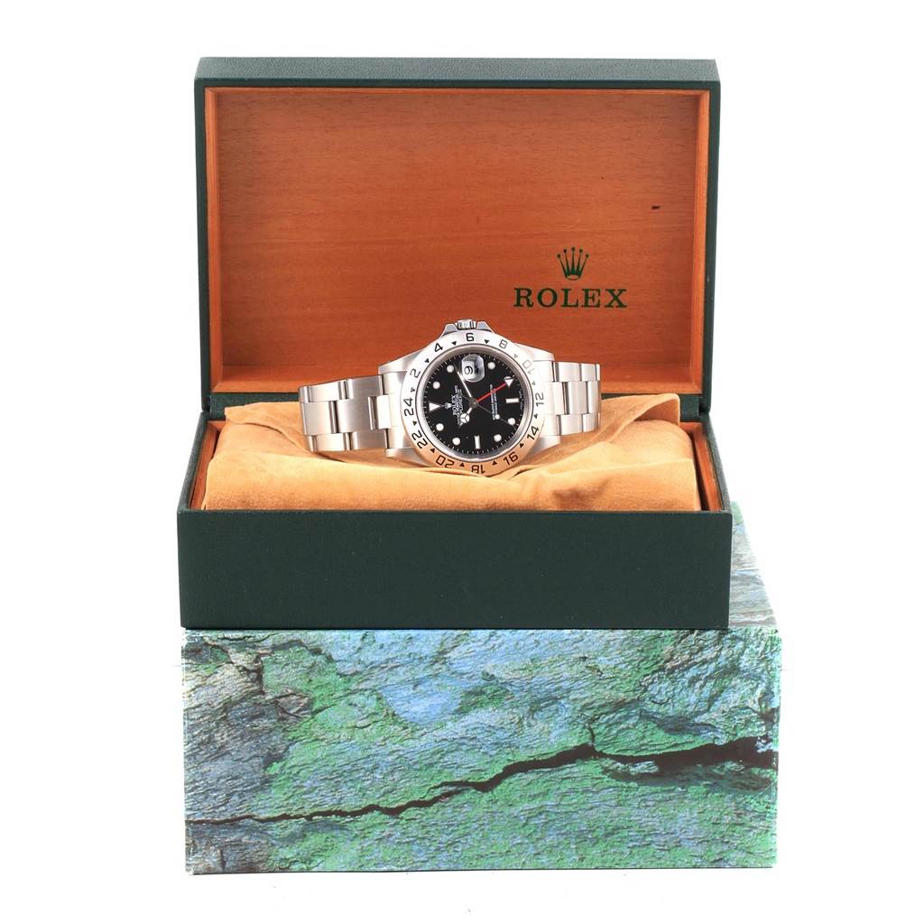 The Rolex Explorer 16570 Men's Stainless Steel Black Dial 16570 Men's Stainless Steel Black Dial watch is shown from the front with the dial, bezel, and strap visible in its open box.