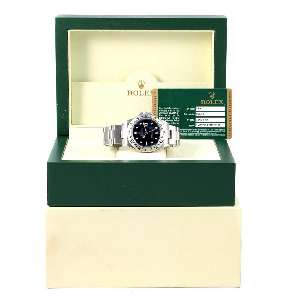 The Rolex Explorer 16570 Men's Stainless Steel Black Dial 16570 Men's Stainless Steel Black Dial watch is shown front-on in an open green and cream box with accompanying authenticity card.