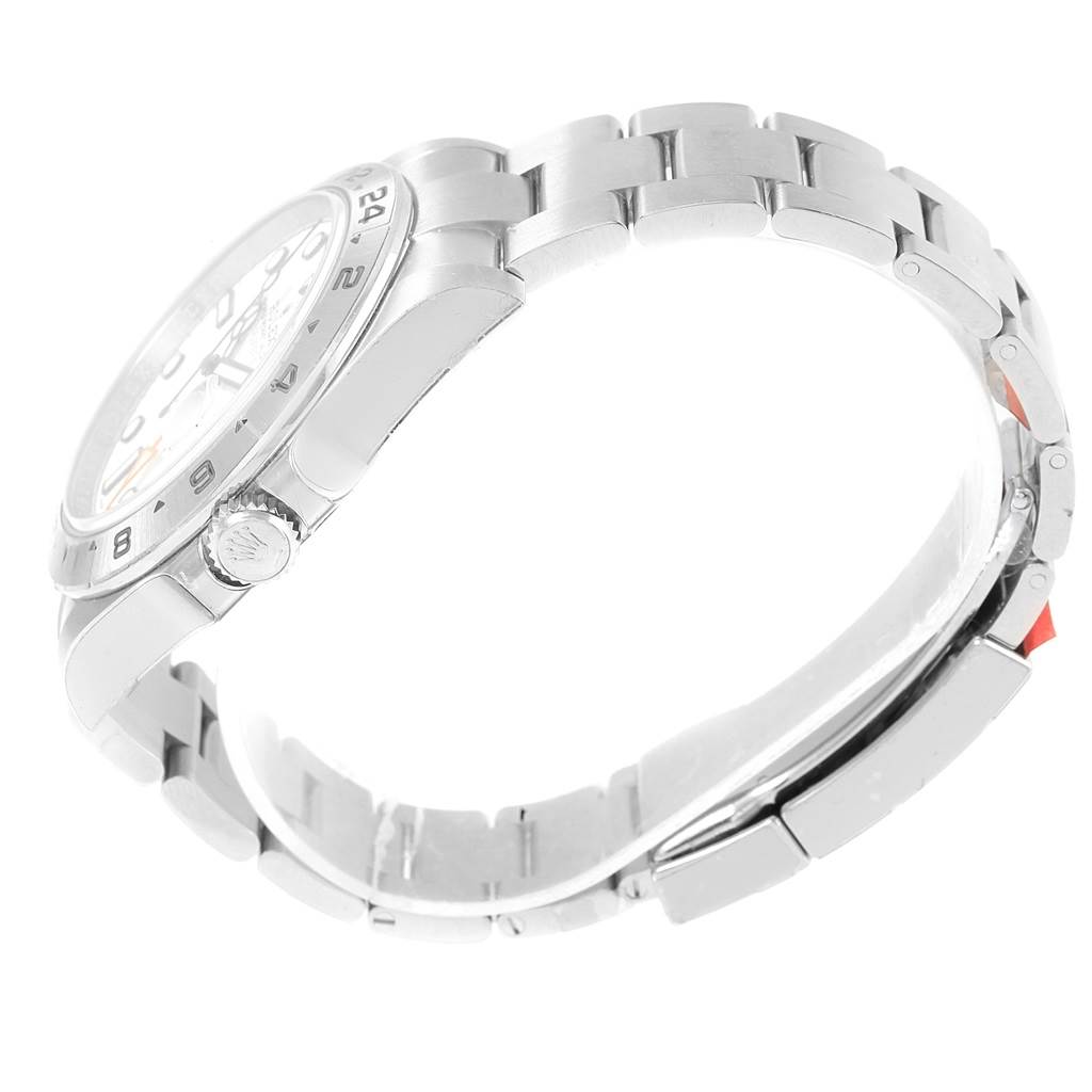 The image shows a side view of the Rolex Explorer 216570 Men's Stainless Steel White Dial 216570 Men's Stainless Steel White Dial watch, highlighting the bracelet, crown, and partial watch face.