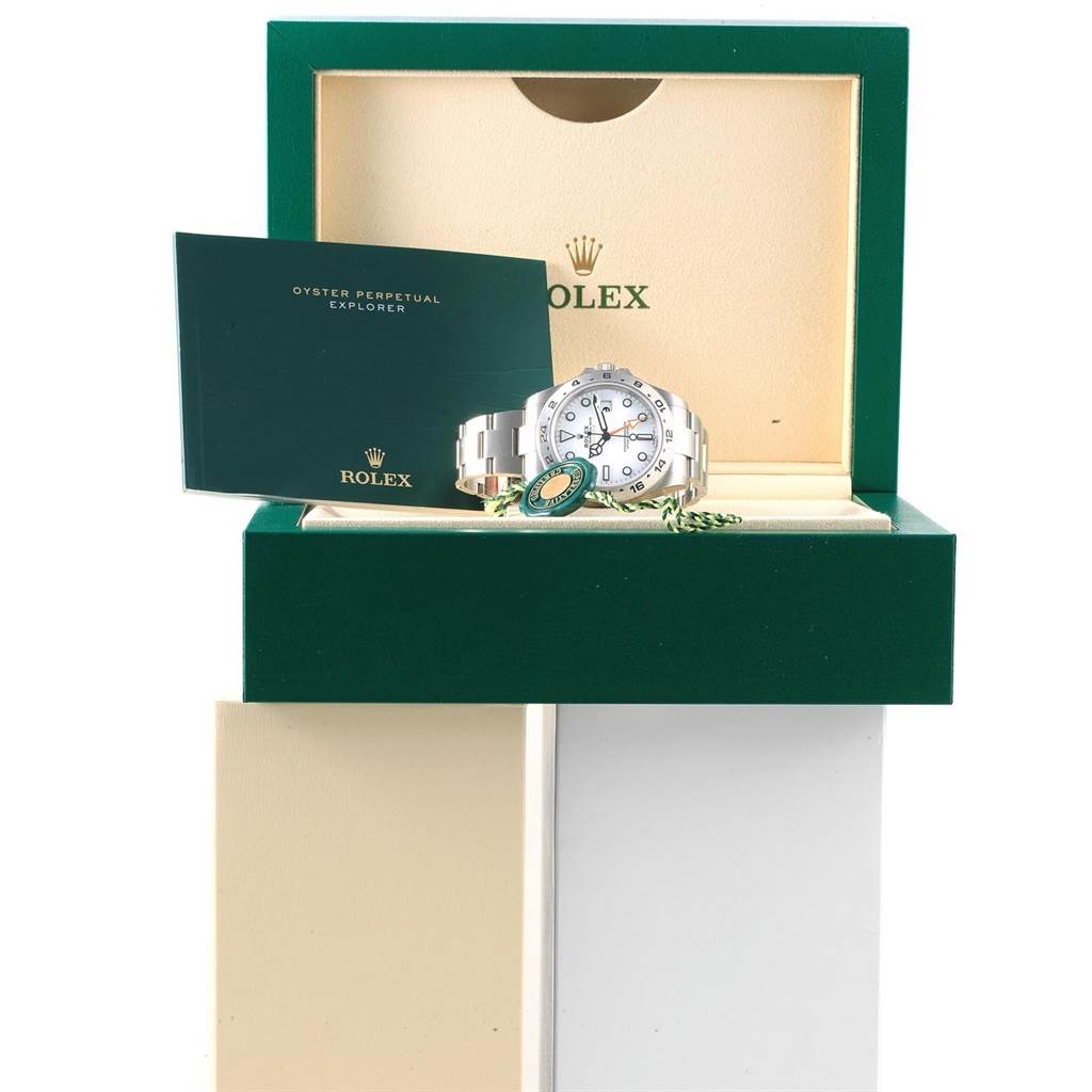 The image shows a Rolex Explorer 216570 Men's Stainless Steel White Dial 216570 Men's Stainless Steel White Dial watch from a front angle, placed inside its open box with the manual and tags visible.