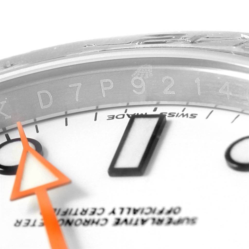 This close-up image of the Rolex Explorer 216570 Men's Stainless Steel White Dial 216570 Men's Stainless Steel White Dial watch shows part of the dial, the edge of the case, and the second hand.