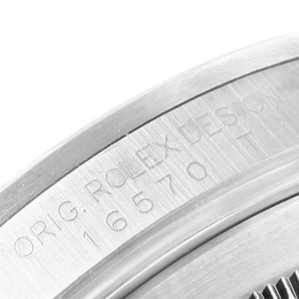 The image shows the engraved case back edge of a Rolex Explorer 16570 Men's Stainless Steel White Dial 16570 Men's Stainless Steel White Dial model, partially displaying the reference number and "ROLEX DESIGN" text.