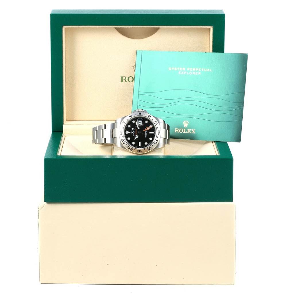 The Rolex Explorer 216570 Men's Stainless Steel Black Dial 216570 Men's Stainless Steel Black Dial watch and its booklet are shown in their open case from a front angle.