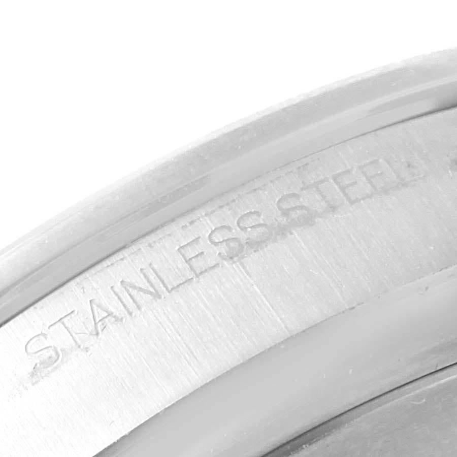 The image shows a close-up of the stainless steel casing of a Rolex Explorer 216570 Men's Stainless Steel Black Dial 216570 Men's Stainless Steel Black Dial model watch.