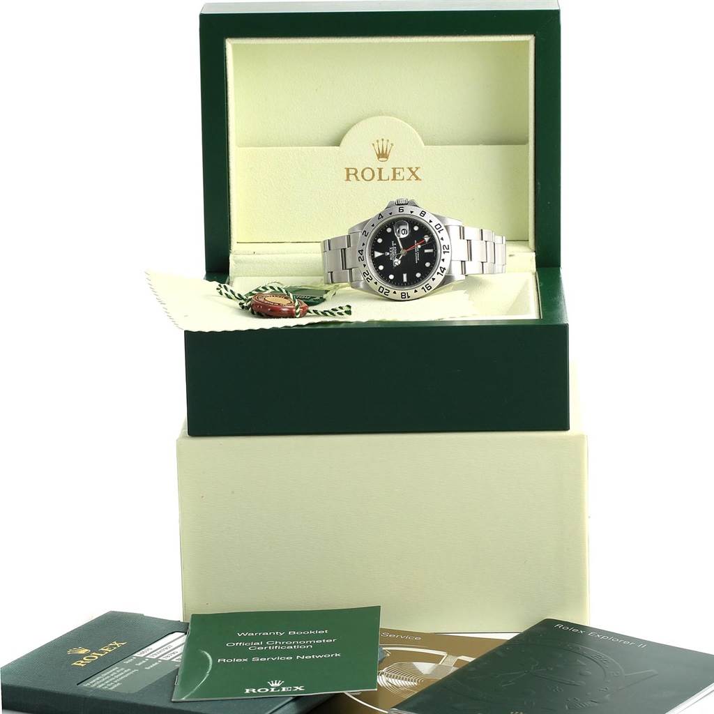 The image shows a Rolex Explorer 16570 Men's Stainless Steel Black Dial 16570 Men's Stainless Steel Black Dial watch at an angle in an open, branded box with accompanying booklets and tags.
