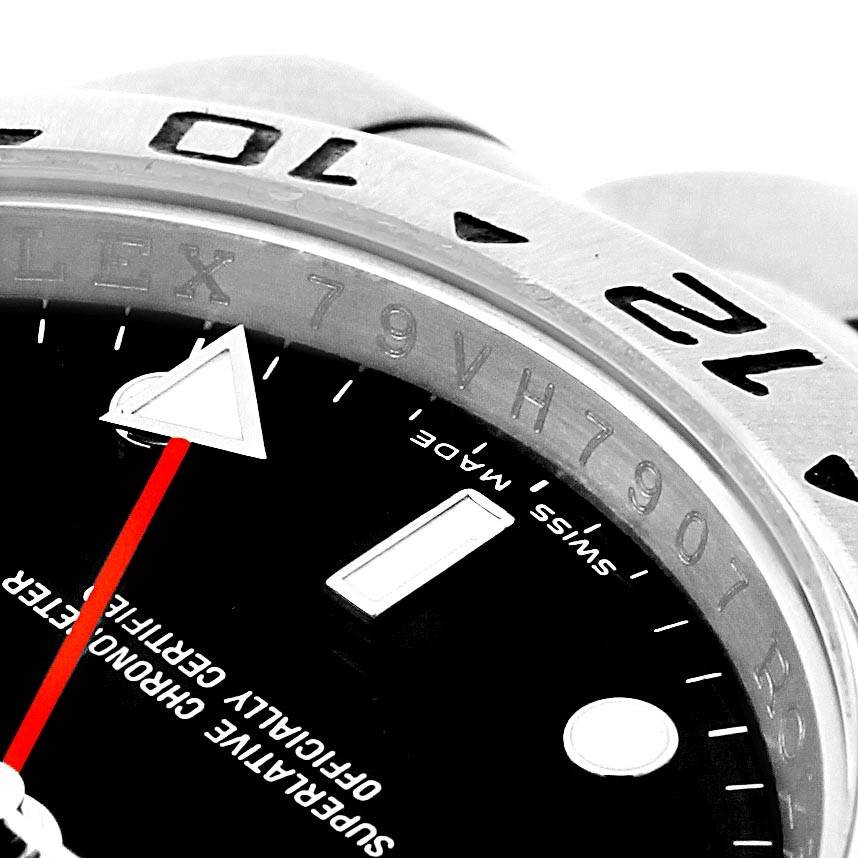 The image shows a close-up of the bezel, dial, and red GMT hand of a Rolex Explorer 16570 Men's Stainless Steel Black Dial 16570 Men's Stainless Steel Black Dial watch.