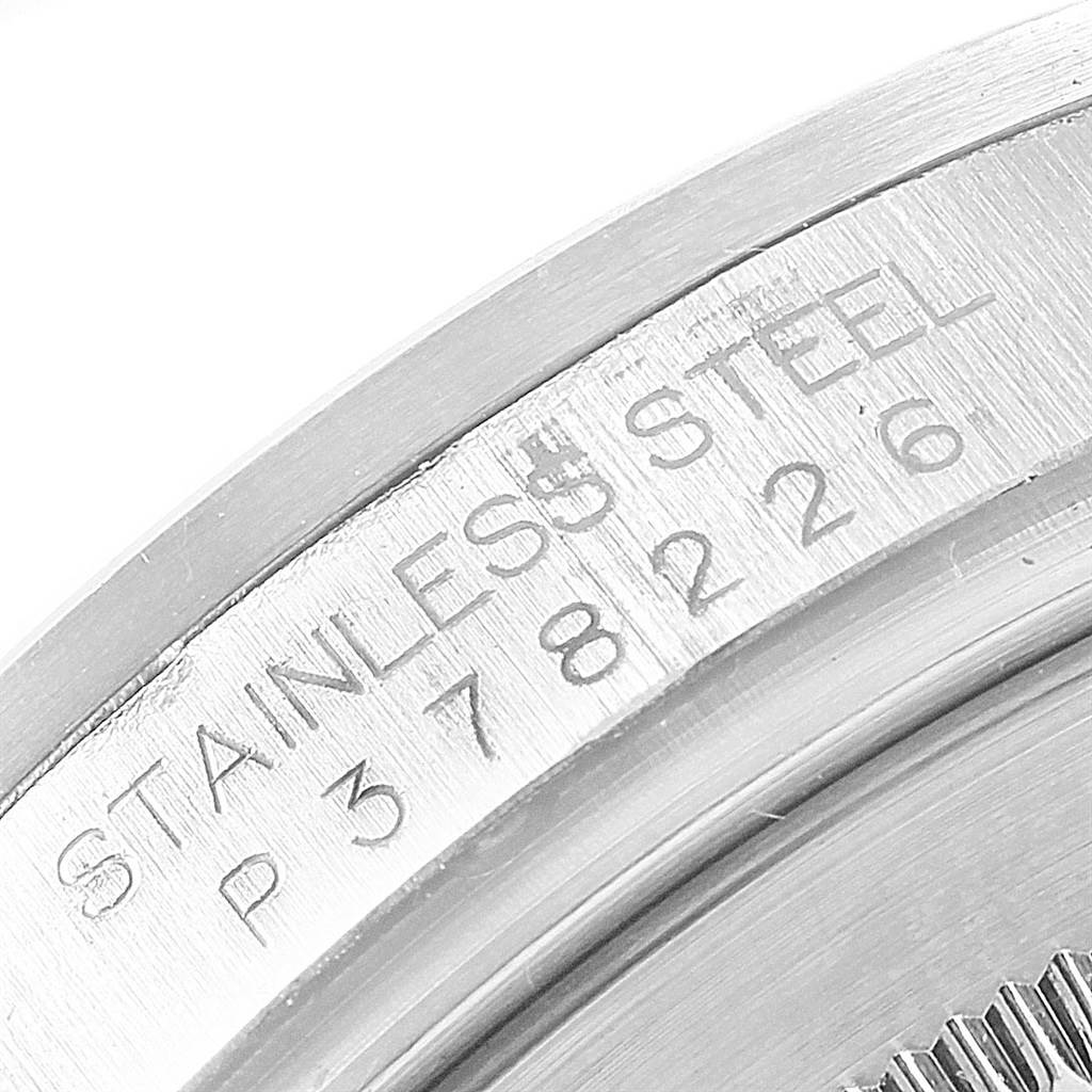 This is a close-up of the case back edge of a Rolex Explorer 16570 Men's Stainless Steel Black Dial 16570 Men's Stainless Steel Black Dial watch, showing its stainless steel marking and serial number.
