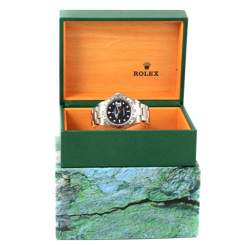 The Rolex Explorer 16570 Men's Stainless Steel Black Dial 16570 Men's Stainless Steel Black Dial watch is shown from the front in an open green and wooden Rolex box.