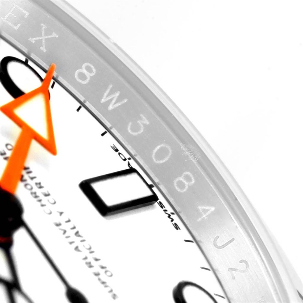 This close-up shows the dial, orange hand, and partial bezel with engravings of a Rolex Explorer 216570 Men's Stainless Steel White Dial 216570 Men's Stainless Steel White Dial watch.