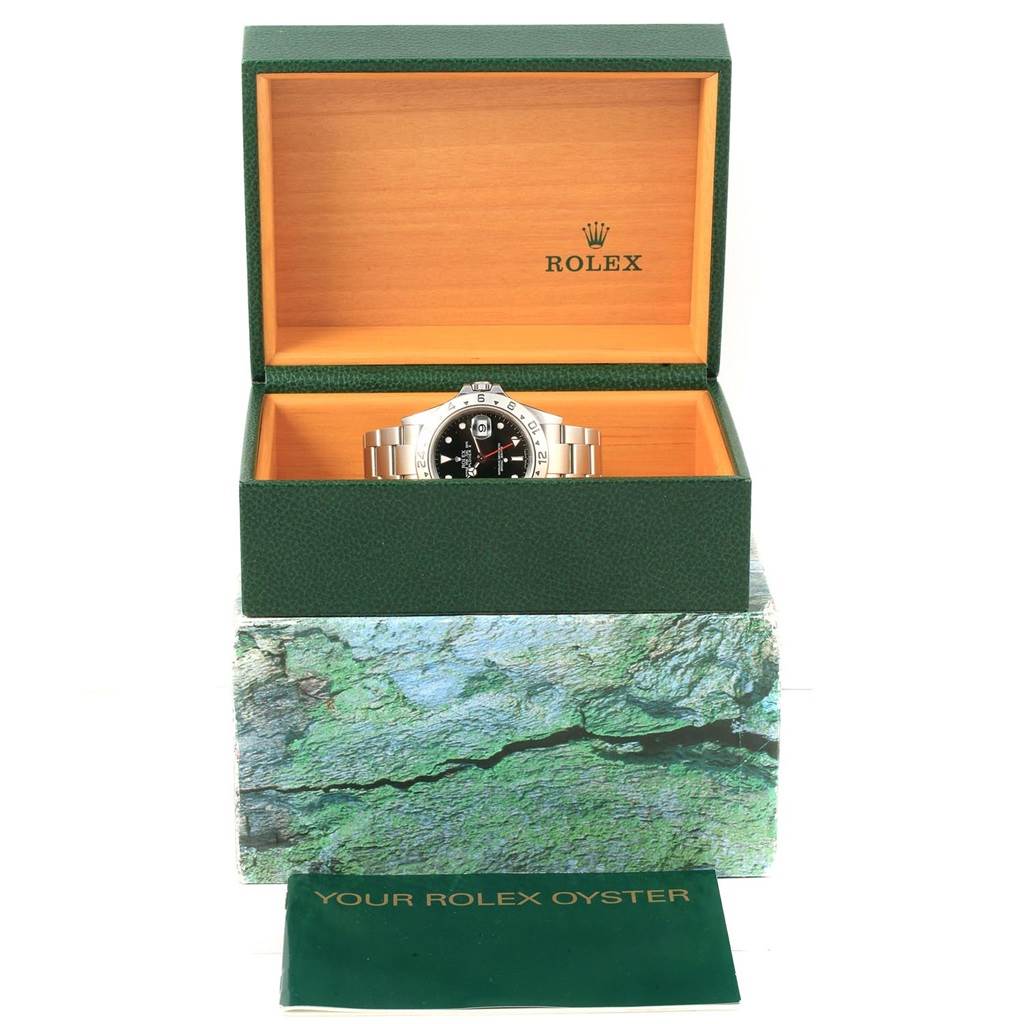 The image shows a Rolex Explorer 16570 Men's Stainless Steel Black Dial 16570 Men's Stainless Steel Black Dial watch displayed in its open green box, with an accompanying booklet placed below it.