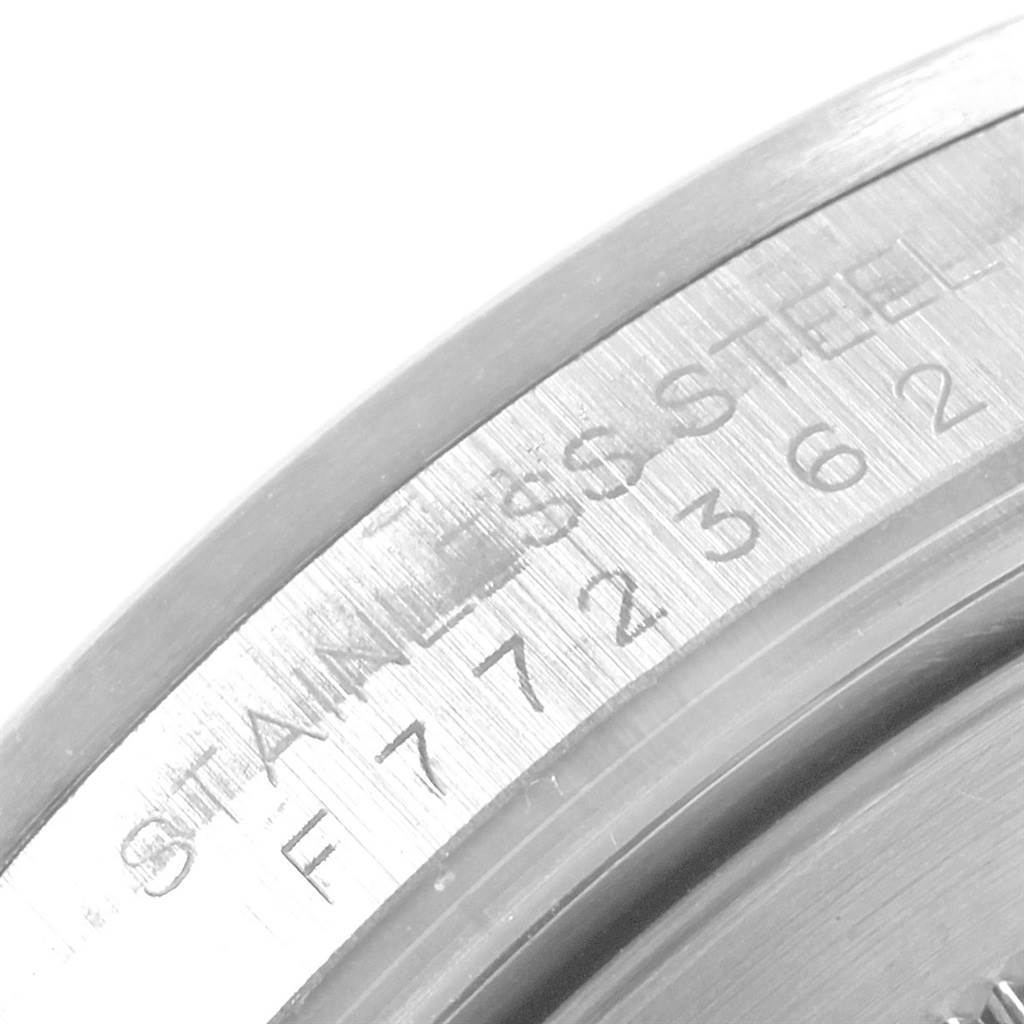 This image shows a close-up of the serial number and "Stainless Steel" engraving on the bezel of a Rolex Explorer 16570 Men's Stainless Steel Black Dial 16570 Men's Stainless Steel Black Dial watch.