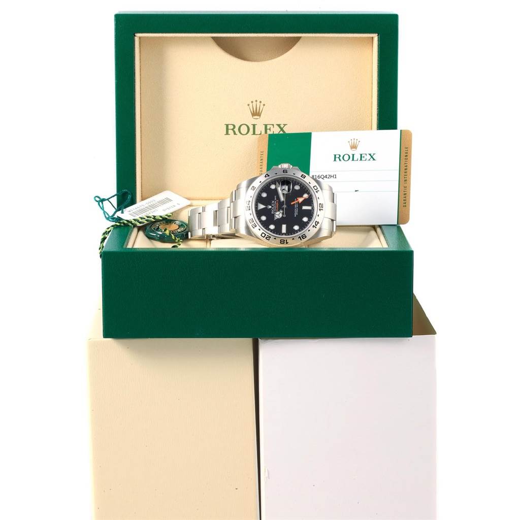 The image shows a Rolex Explorer 216570 Men's Stainless Steel Black Dial 216570 Men's Stainless Steel Black Dial model watch in its open box with tags and a warranty card.