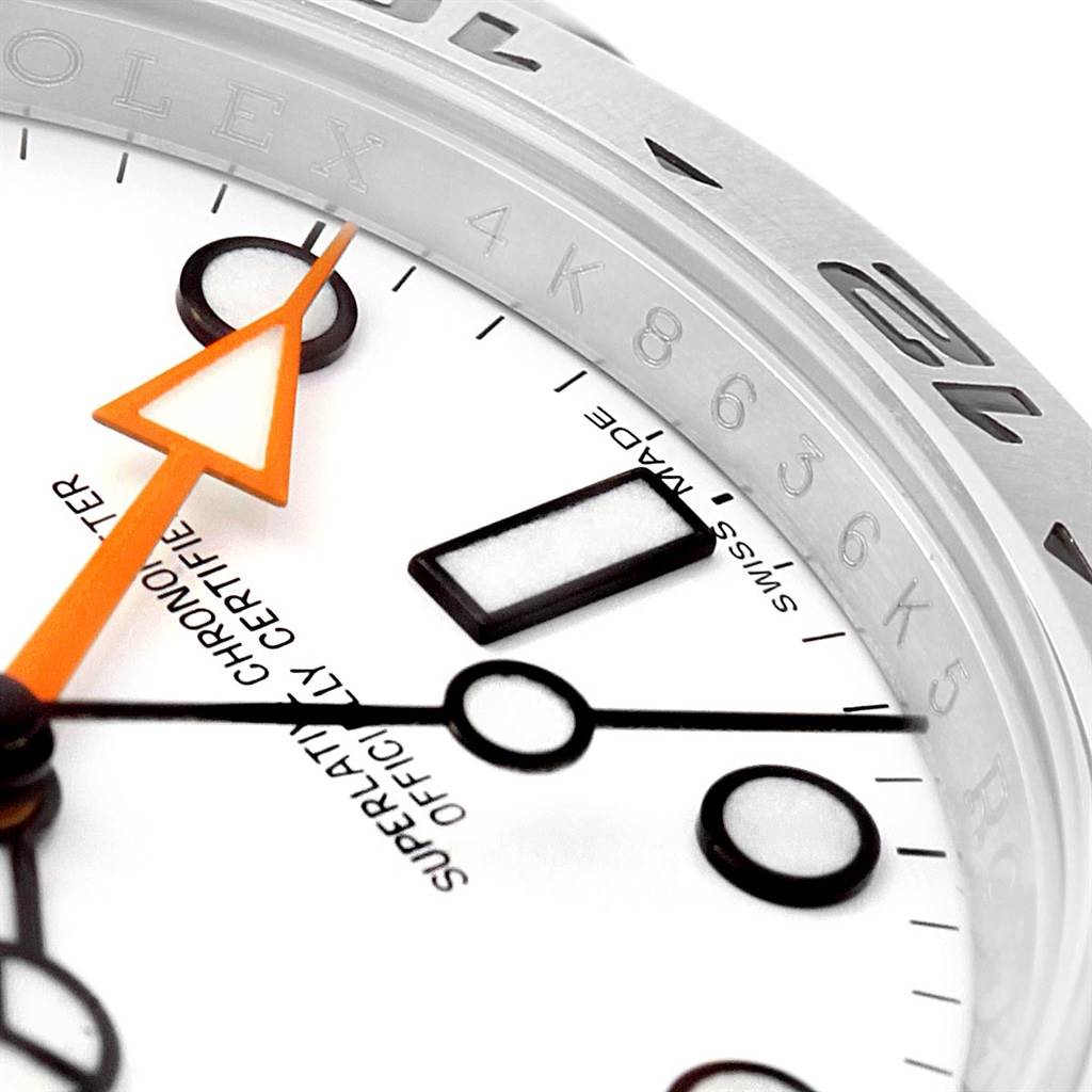This close-up image shows the dial, minute markers, and orange hand of a Rolex Explorer 216570 Men's Stainless Steel White Dial 216570 Men's Stainless Steel White Dial watch.