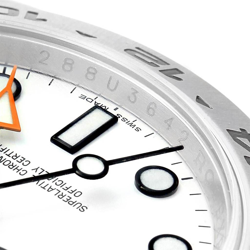 This close-up image of a Rolex Explorer 216570 Men's Stainless Steel White Dial 216570 Men's Stainless Steel White Dial watch shows part of the dial, hour markers, hands, and bezel.