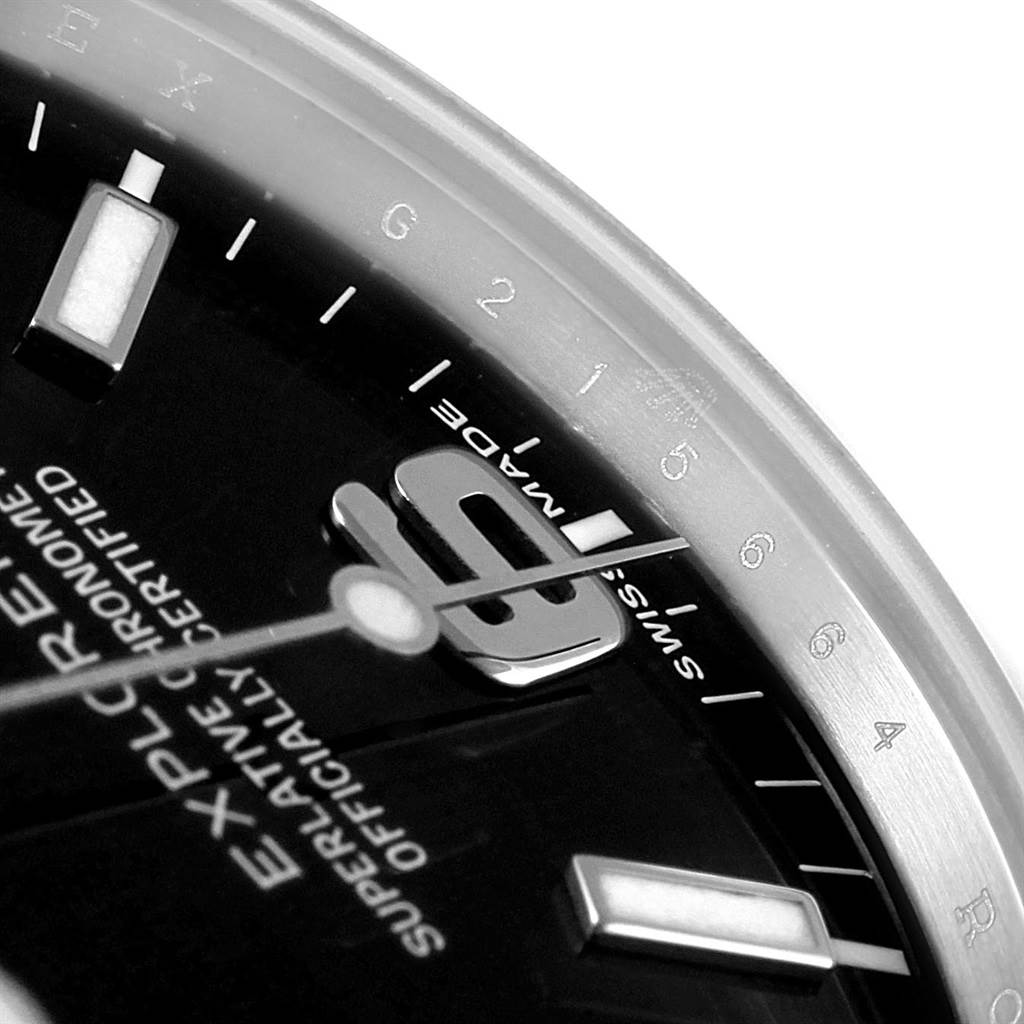 This close-up image of the Rolex Explorer 214270 Men's Stainless Steel Black Dial 214270 Men's Stainless Steel Black Dial watch shows the dial, hands, bezel, and part of the hour markers.