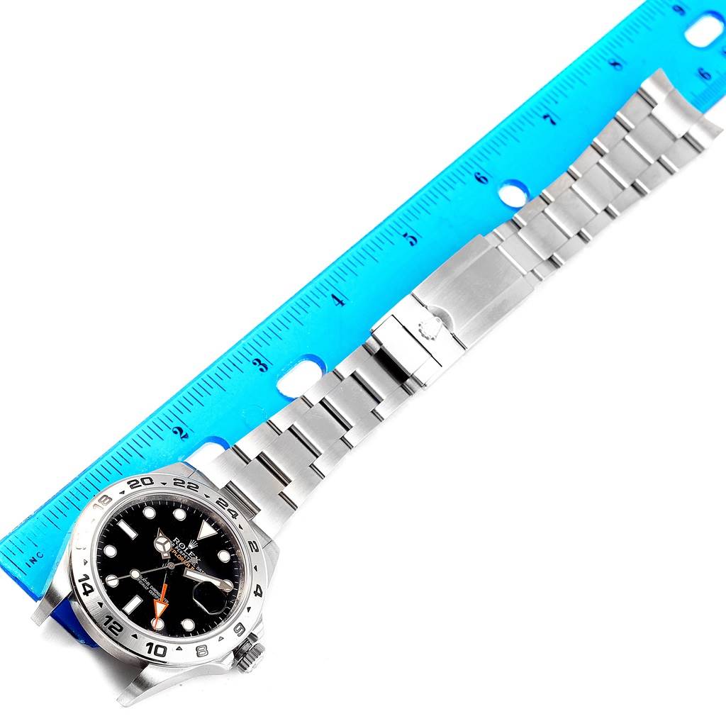 The Rolex Explorer 216570 Men's Stainless Steel Black Dial 216570 Men's Stainless Steel Black Dial watch is shown from the front with a full view of the face and bracelet, measured by a ruler.