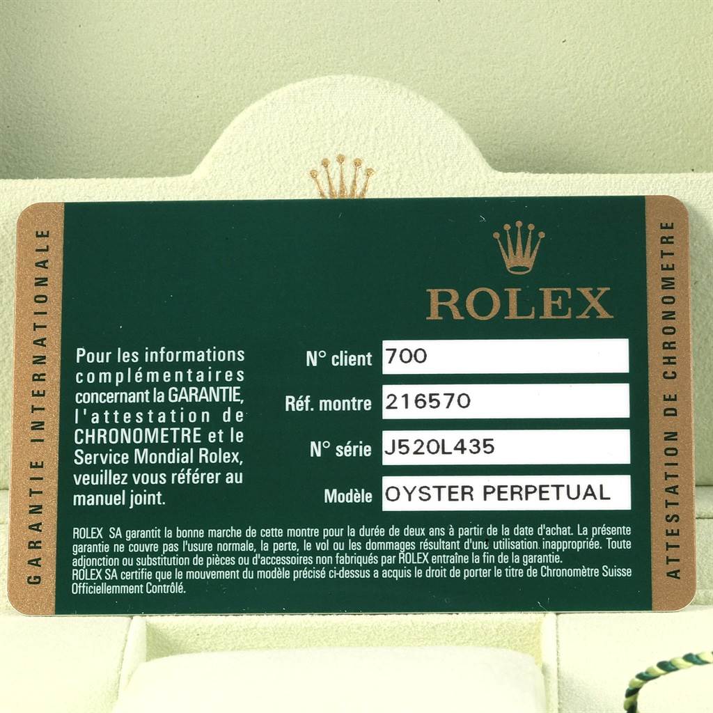 The image shows a warranty card for the Rolex Explorer 216570 Men's Stainless Steel Black Dial 216570 Men's Stainless Steel Black Dial model, displaying the brand, model, and reference numbers.