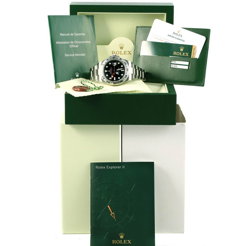The image shows a Rolex Explorer 216570 Men's Stainless Steel Black Dial 216570 Men's Stainless Steel Black Dial watch with its box, manuals, warranty cards, and additional accessories.
