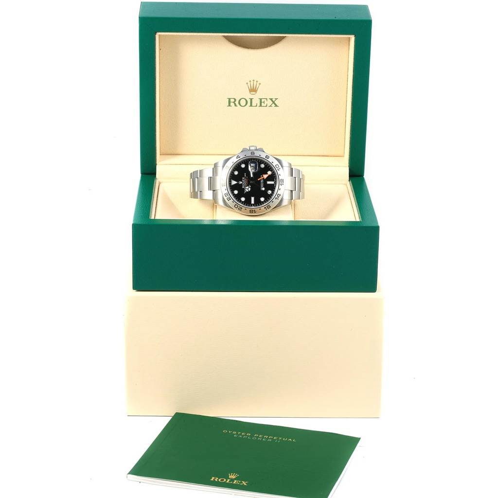 The Rolex Explorer 216570 Men's Stainless Steel Black Dial 216570 Men's Stainless Steel Black Dial watch is shown from a front angle in its original box with accompanying documentation.