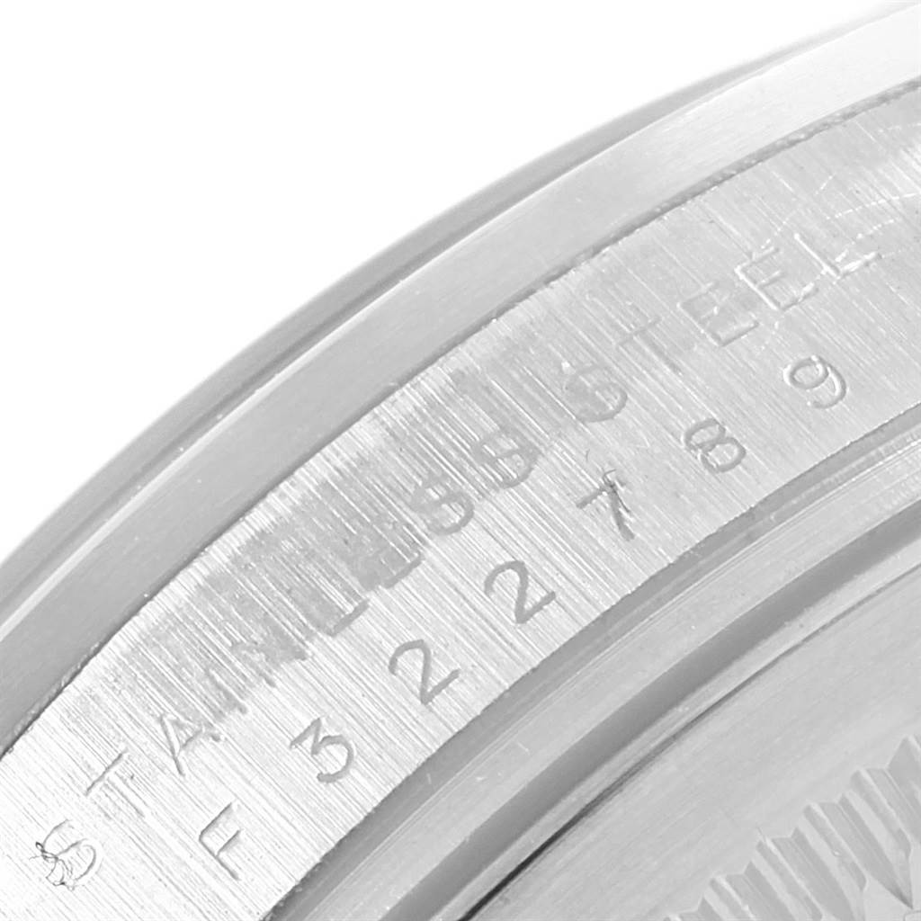 This image shows a close-up of the engraved serial and reference numbers on the side of the Rolex Explorer 114270 Men's Stainless Steel Black Dial 114270 Men's Stainless Steel Black Dial's case.