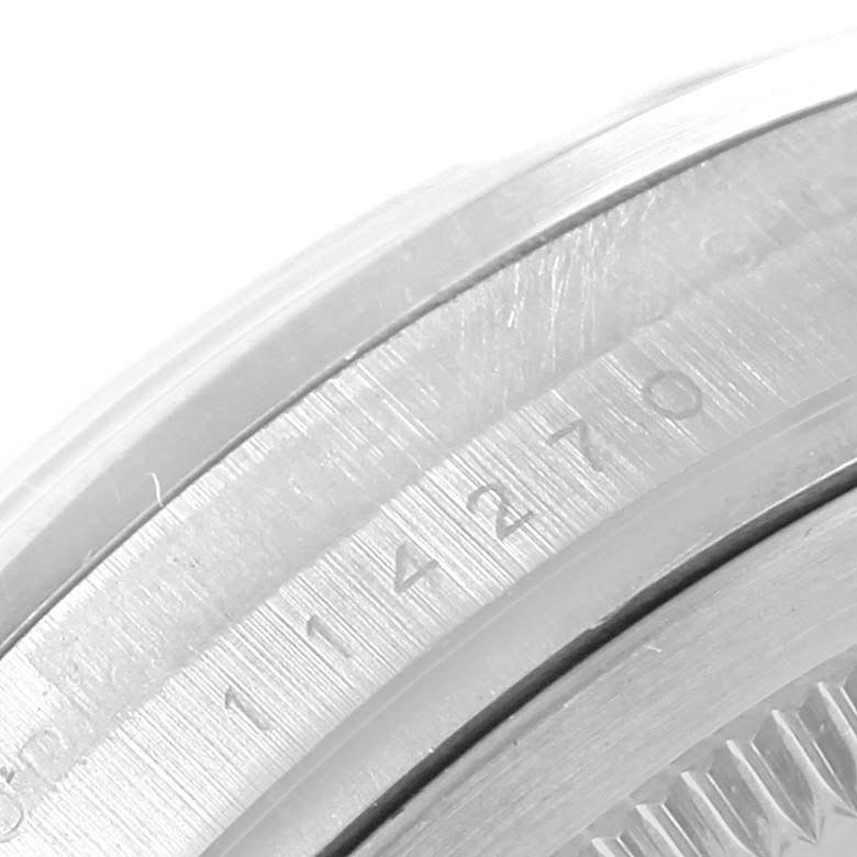 This close-up image shows part of the case and serial number engraving on a Rolex Explorer 114270 Men's Stainless Steel Black Dial 114270 Men's Stainless Steel Black Dial model.