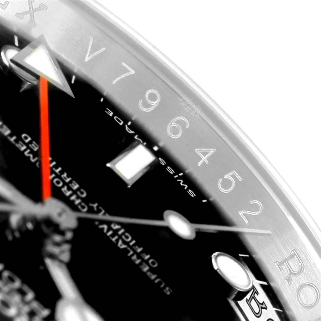 The image shows a close-up of the Rolex Explorer 16570 Men's Stainless Steel Black Dial 16570 Men's Stainless Steel Black Dial watch's dial, showcasing a segment of the bezel and indices with part of the second hand visible.