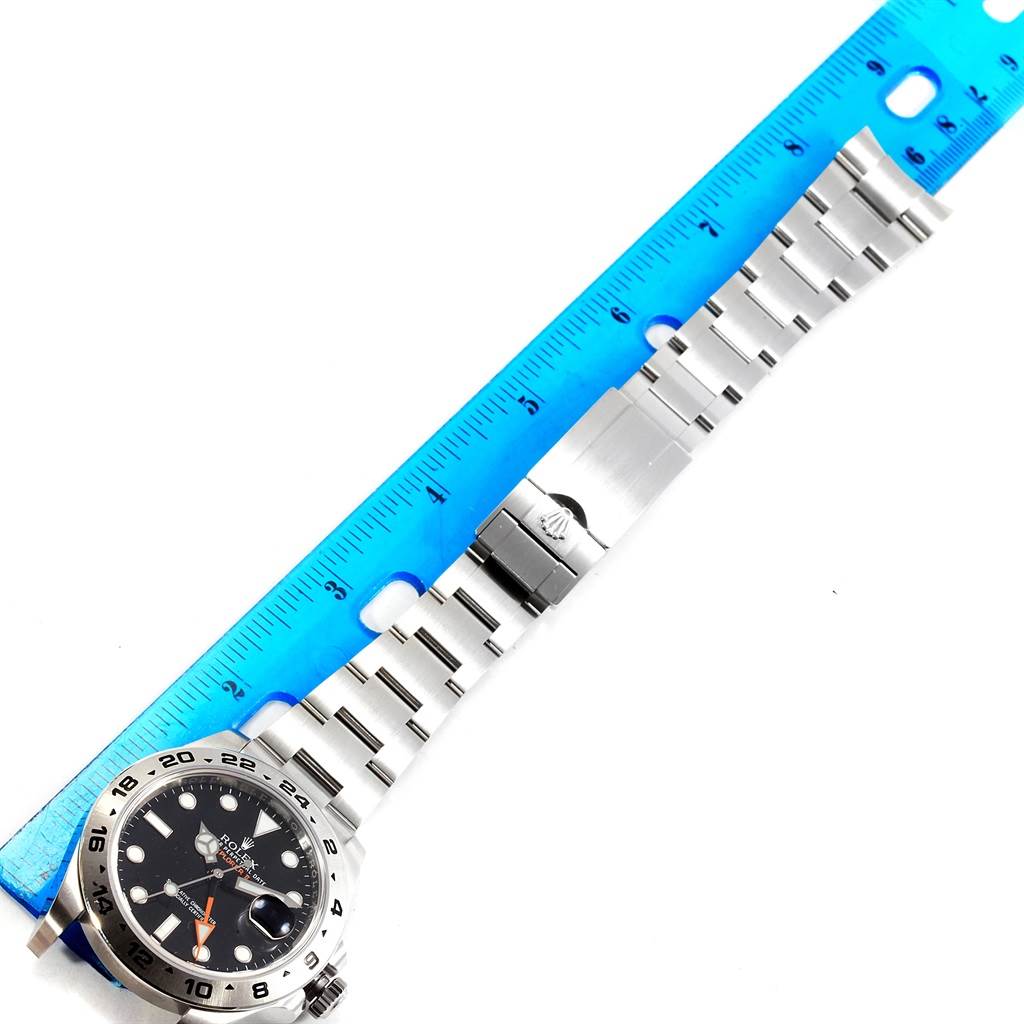 The image shows a Rolex Explorer 216570 Men's Stainless Steel Black Dial 216570 Men's Stainless Steel Black Dial watch laid flat with its bracelet extended and measured by a ruler.