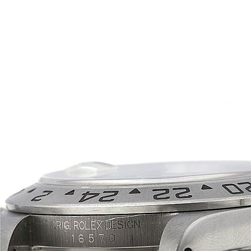 The image shows a close-up of the side and bezel of the Rolex Explorer 16570 Men's Stainless Steel White Dial 16570 Men's Stainless Steel White Dial model 16570, highlighting the engraved design and numbering.