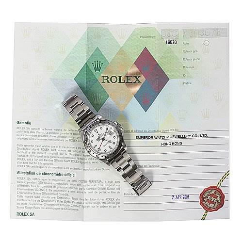 The image shows a Rolex Explorer 16570 Men's Stainless Steel White Dial 16570 Men's Stainless Steel White Dial watch placed on top of its warranty certification document.