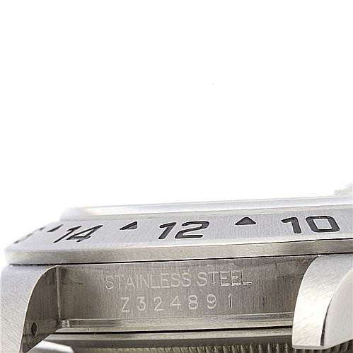 The image shows a close-up of the side of a Rolex Explorer 16570 Men's Stainless Steel Black Dial 16570 Men's Stainless Steel Black Dial watch, featuring the bezel, case, and engraved serial number.