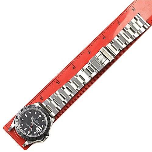 The image shows a Rolex Explorer 16570 Men's Stainless Steel Black Dial 16570 Men's Stainless Steel Black Dial watch laid flat alongside a ruler, highlighting the entire bracelet and watch face.