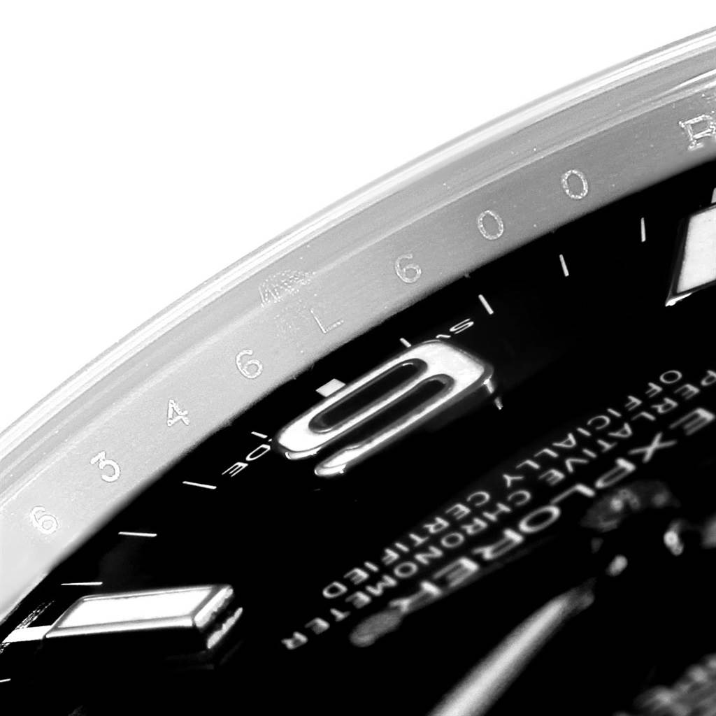 The image shows a close-up of the Rolex Explorer 214270 Men's Stainless Steel Black Dial 214270 Men's Stainless Steel Black Dial watch, focusing on the bezel, part of the dial, and the 9-hour marker.
