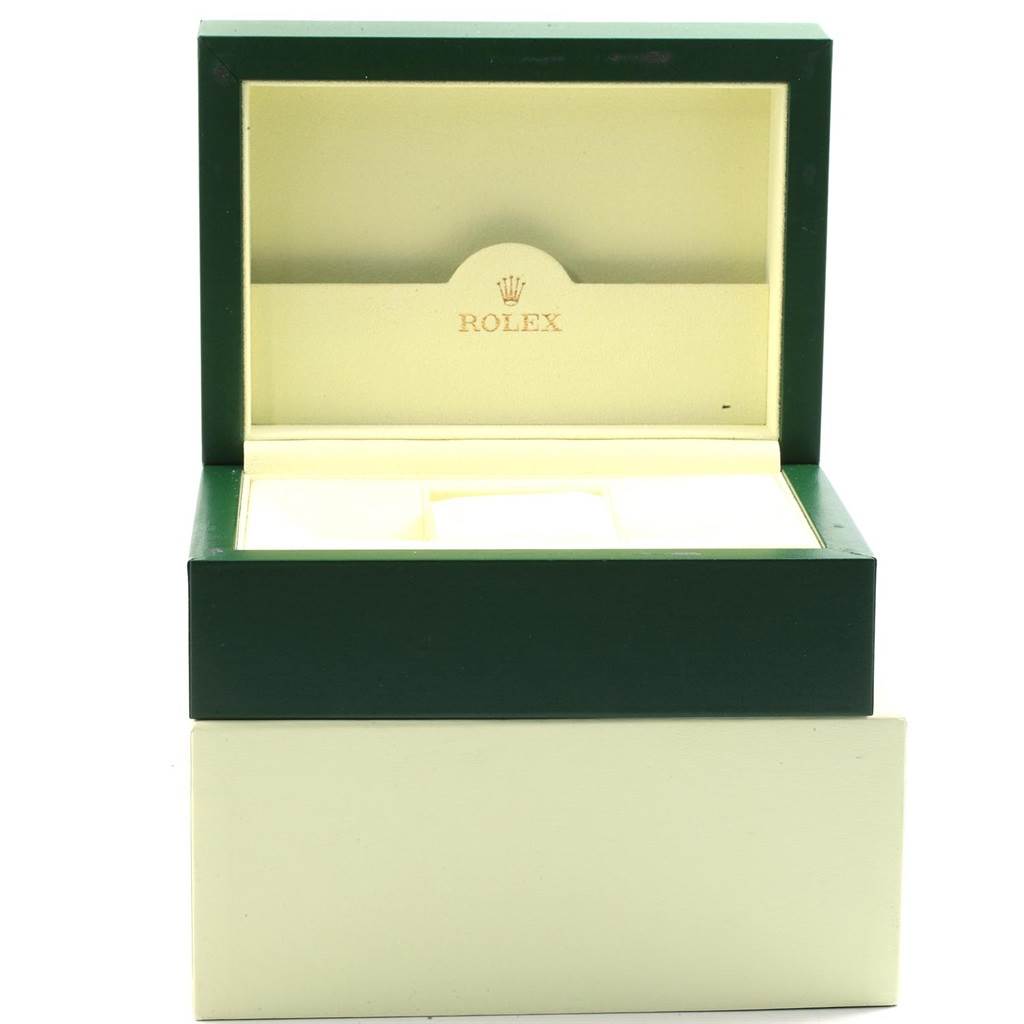 This image shows an open green and cream Rolex watch box for the Explorer model.