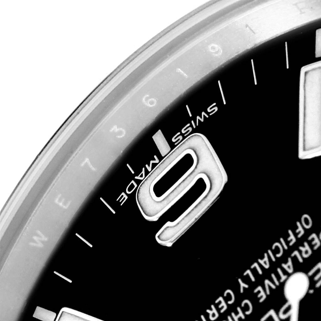 This close-up angle of the Rolex Explorer 214270 Men's Stainless Steel Black Dial 214270 Men's Stainless Steel Black Dial watch shows part of the dial, specifically the "Swiss Made" label and the number 9.
