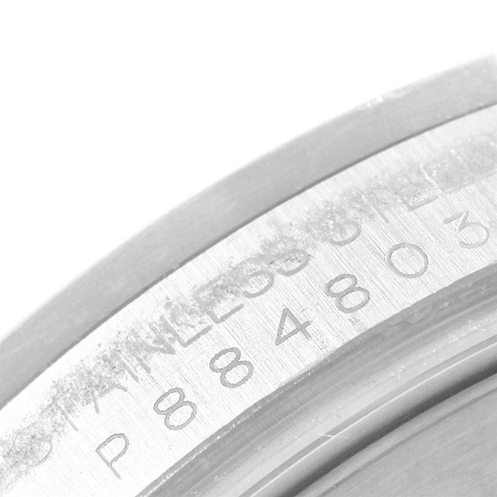 This close-up image shows the edge of the case back of the Rolex Explorer 16570 Men's Stainless Steel White Dial 16570 Men's Stainless Steel White Dial model, highlighting the serial number and "STAINLESS STEEL" engraving.
