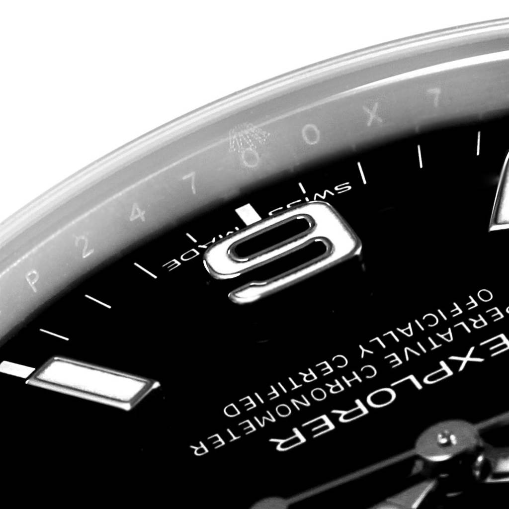 Close-up of the dial on a Rolex Explorer 214270 Men's Stainless Steel Black Dial 214270 Men's Stainless Steel Black Dial watch, showing part of the 9 o'clock marker and the surrounding text.