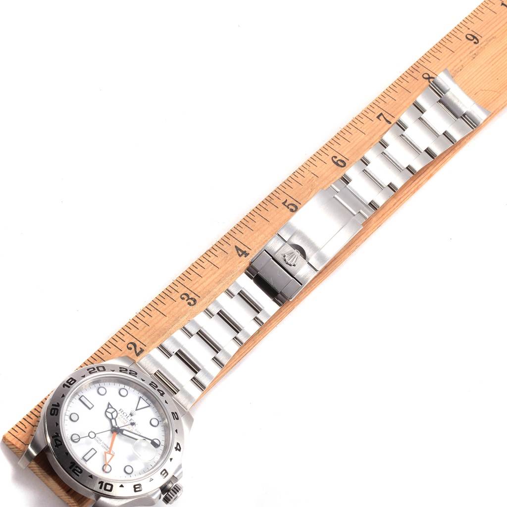 The image shows a Rolex Explorer 216570 Men's Stainless Steel White Dial 216570 Men's Stainless Steel White Dial watch laid flat next to a ruler, displaying its face and bracelet.