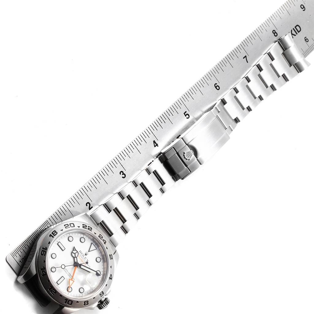 The image shows a Rolex Explorer 216570 Men's Stainless Steel White Dial 216570 Men's Stainless Steel White Dial watch laid flat with its bracelet extended beside a ruler for scale reference.