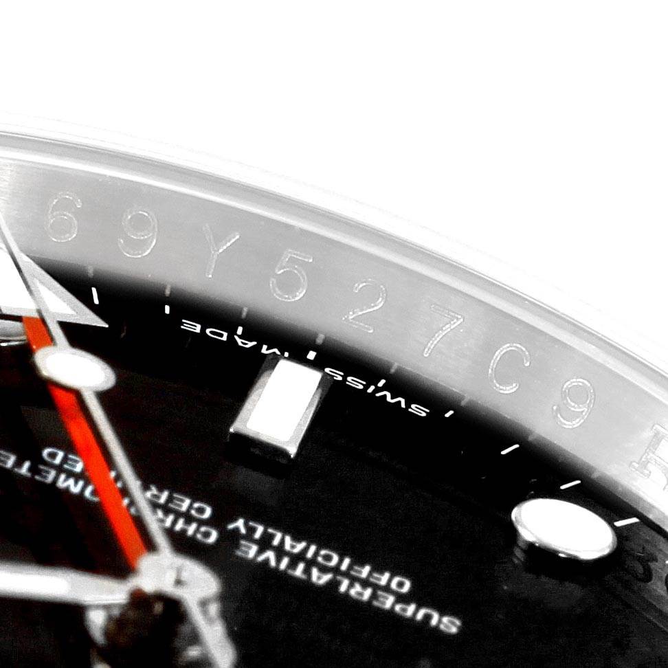 The image shows a macro shot of the Rolex Explorer 16570 Men's Stainless Steel Black Dial 16570 Men's Stainless Steel Black Dial watch's serial number engraving on the rehaut and part of the dial with the hands.