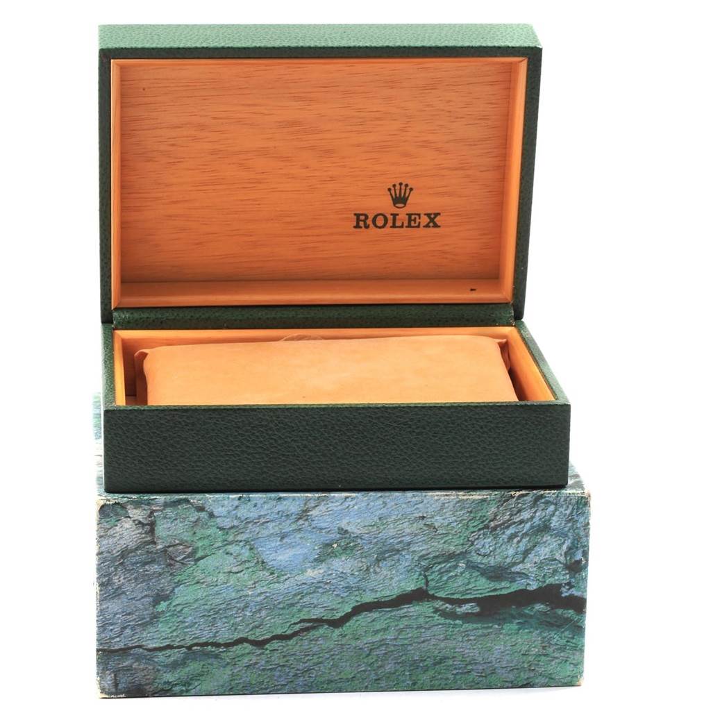 This image displays the opened box of a Rolex Explorer 16570 Men's Stainless Steel Black Dial 16570 Men's Stainless Steel Black Dial watch, revealing the interior and the cushion where the watch would be placed.